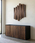 Load image into Gallery viewer, Modern interior with a wooden sideboard and abstract wall sculpture.
